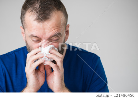 Man blowing nose 121480450