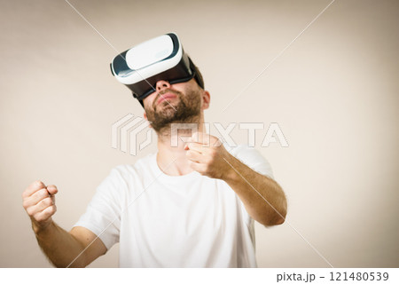 Adult man wearing vr goggles 121480539
