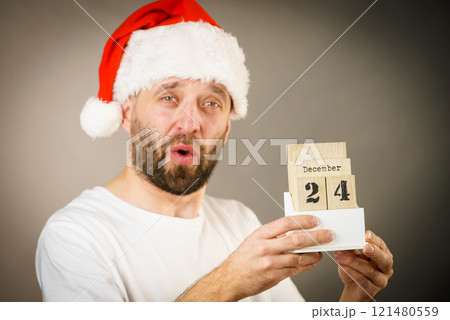 December 24th. Man santa hat holds calender 121480559
