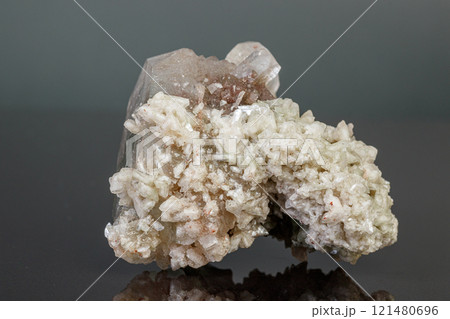macro mineral stone Apophyllite stilbite on a gray background macro mineral stone Apophyllite stilbite on a gray background 121480696