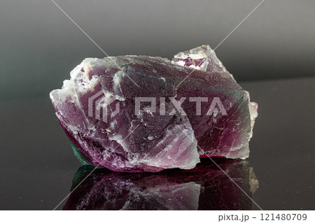 macro mineral stone red and green fluorite on a black background 121480709