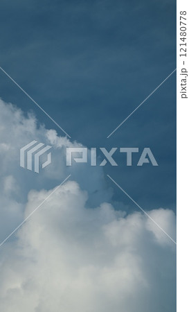 Sunny And Windy Weather Sky With Blue Tones. Cloud Is Aerosol Comprising Visible Mass Of Liquid Droplets. Vertical Time Lapse. 121480778
