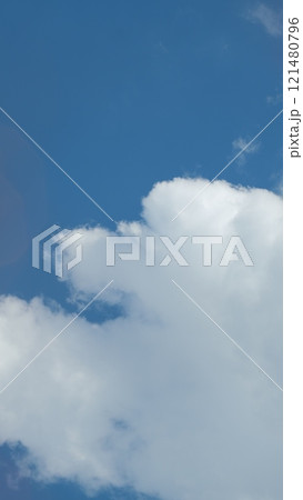 Sky Blue Or Azure Sky And Clouds. Soft White Clouds On Pastel Blue Sky Background. Vertical Time Lapse. Sky Blue Or Azure Sky And Clouds. Soft White Clouds On Pastel Blue Sky Background. Vertical Time Lapse. 121480796