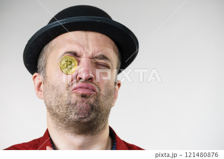 Man having bitcoin in eye 121480876