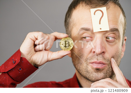 Adult man questioning bitcoin Adult man questioning bitcoin 121480909