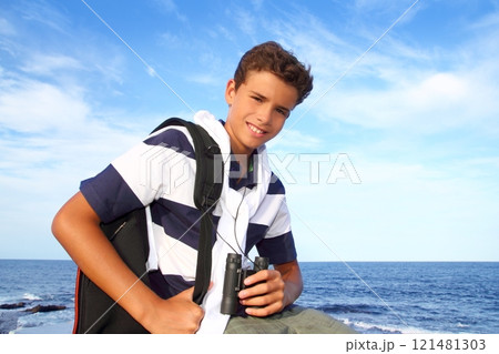 boy teenager binoculars explorer in blue beach 121481303