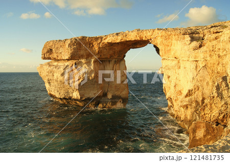 A natural stone arch called Azure Window on the Gozo island, Malta in a golden hour before sunset 121481735
