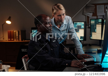 Guards watching cctv video record Guards watching cctv video record 121481996