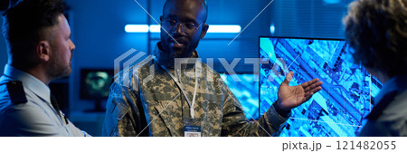 Officer pointing at interactive screen 121482055