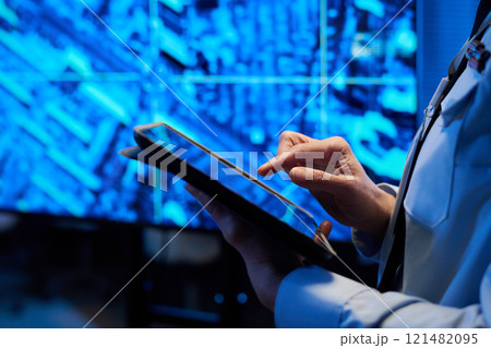 Officer in uniform pointing at screen 121482095