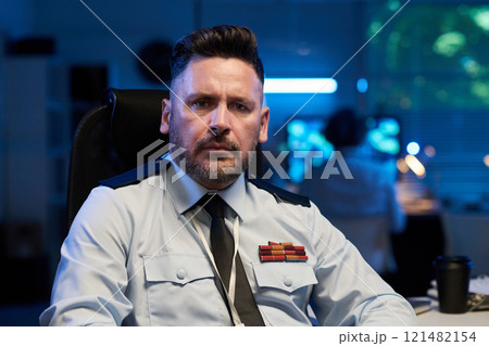 Serious officer in light blue uniform 121482154