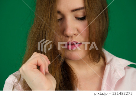 Studio portrait of a beautiful young woman with brown hair. Pretty model girl with perfect fresh clean skin looking down. Fashion model, beauty, wellness, people, healthy lifestyle concept 121482273