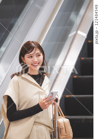 空港に到着しエスカレーターからか降りてくる女性 121484549