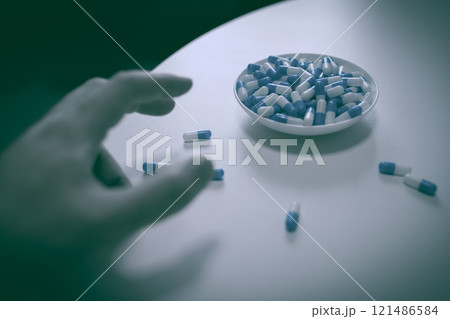 オーバードーズ　ODイメージ　大量の薬を接種する手　薬物過剰摂取　ストレス　鬱病　若年層　社会問題 121486584