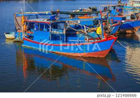 There are many traditional Vietnamese fishing boats and vessels in the bay on the river in Nha Trang There are many traditional Vietnamese fishing boats and vessels in the bay on the river in Nha Trang 121486666