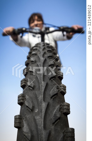 Woman on a bicycle Woman on a bicycle 121489012