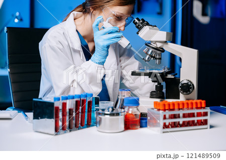 Scientist mixing chemical liquids in the chemistry lab. Researcher working Scientist mixing chemical liquids in the chemistry lab. Researcher working 121489509