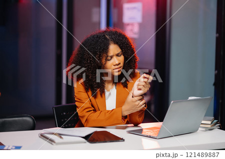 Business woman drinking coffee to get some energy for working overtime sitting at desk using computer and doing overtime project Business woman drinking coffee to get some energy for working overtime sitting at desk using computer and doing overtime project 121489887