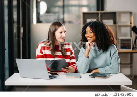 Businesswoman leading team working and using tablet and laptop computer with financial in office 121489909