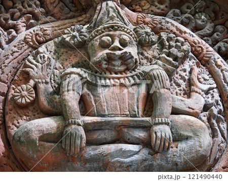 Statue of a man sitting on a rock Statue of a man sitting on a rock 121490440