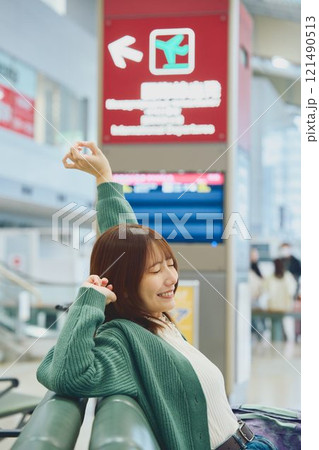 空港で搭乗を待つこれから一人旅に出かける女性 121490513