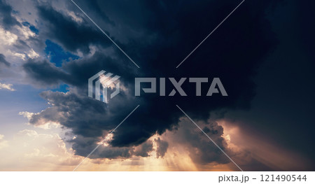 dark dramatic clouds in cloudy sky in a storm and rain at sunset dark dramatic clouds in cloudy sky in a storm and rain at sunset 121490544