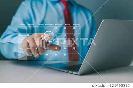 Calendar for monthly appointments and planning, Managing his business schedule, Hand marking dates on virtual calendar, Setting reminders for important appointments, Agenda plan and schedule event. 121490556