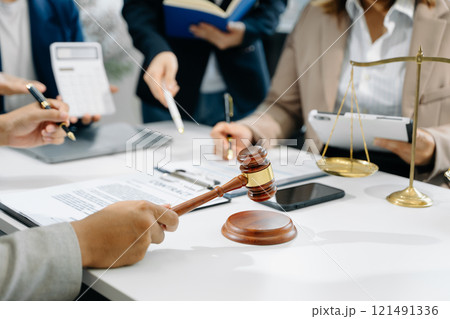 business people and lawyers discussing contract papers sitting at the table. Concepts of law, advice, legal services. 121491336