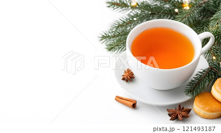 A cozy tea setting with a teacup, teapot, and fresh pastries, surrounded by warm lighting 121493187