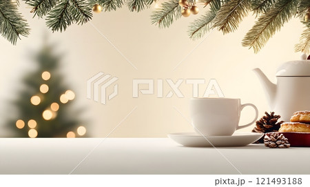 A cozy tea setting with a teacup, teapot, and fresh pastries, surrounded by warm lighting 121493188