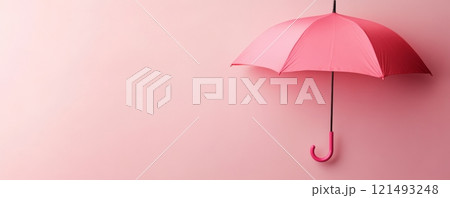 Pink umbrella on light pink background 121493248