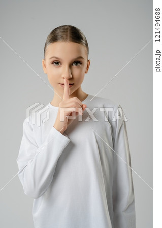 Young girl showcasing dance artistry with poised expression in studio setting 121494688