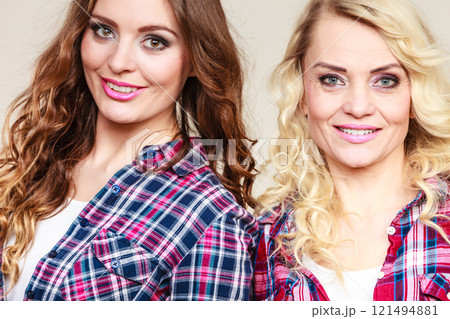 Portrait adult daughter with mother. 121494881