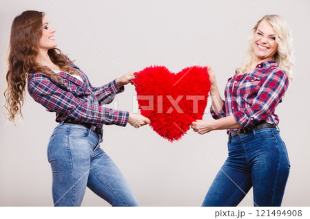 adult daughter and mother with heart love sign 121494908
