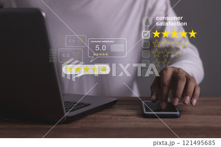Consumer Satisfaction, Young Man hand using Smart Phone and laptop with five star to review Consumer Satisfaction, Young Man hand using Smart Phone and laptop with five star to review 121495685