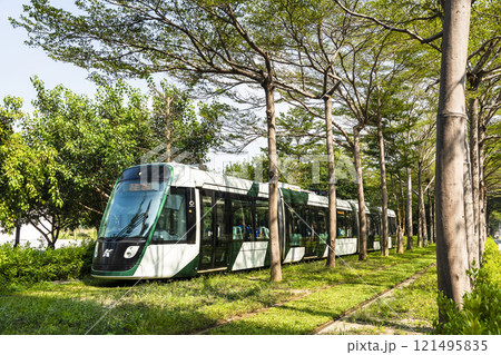 The circular light rail train drives past the Kaohsiung Museum of Fine Arts station in Taiwan. 121495835