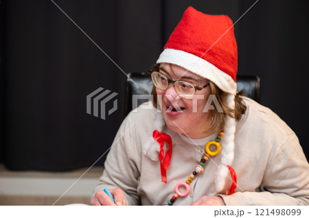 Cosy moment with a 42 yo woman with Down Syndrome, celebrating Christmas at home, Brussels, Belgium Cosy moment with a 42 yo woman with Down Syndrome, celebrating Christmas at home, Brussels, Belgium 121498099