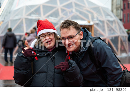 42 yo Down Syndrome woman and her 45 yo brother at the Christmas market in Brussels, Belgium 121498293