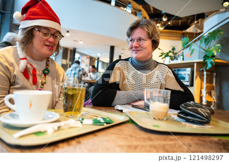 Down Syndrome woman and her female friend drinking tea and cappuccino, Brussels, Belgium Down Syndrome woman and her female friend drinking tea and cappuccino, Brussels, Belgium 121498297