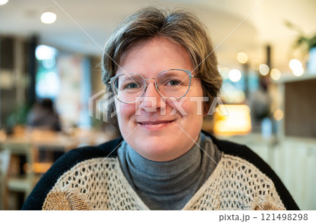 Indoor portrait of a 38 yo white woman in a cafe, Brussels, Belgium Indoor portrait of a 38 yo white woman in a cafe, Brussels, Belgium 121498298