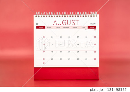 August 2025 blank desk calendar on red color background. 121498585