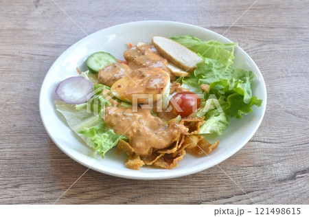 fresh vegetable topping boiled egg topping crispy fried taro dressing Indian sauce salad on plate  121498615