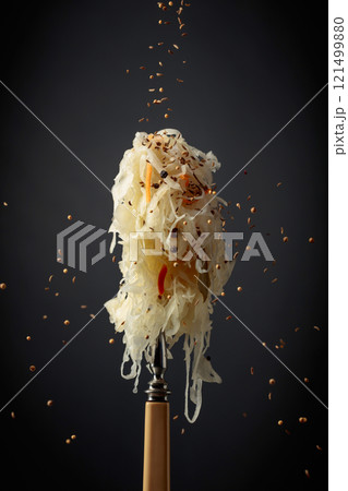 Traditional German sauerkraut with spices on a fork. 121499880