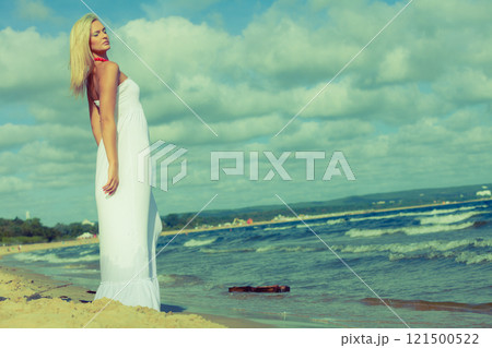 Young lady resting on beach. 121500522
