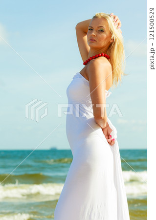 Girl posing in front of sea 121500529