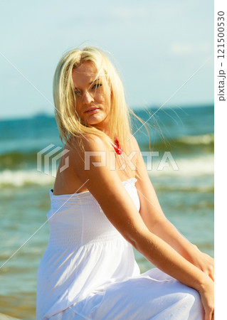Young lady on sunny beach. 121500530