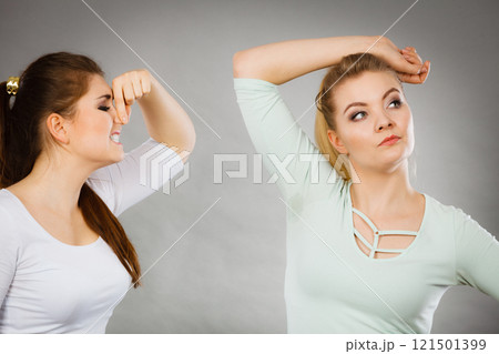 Woman having wet armpit her friend smelling stink 121501399