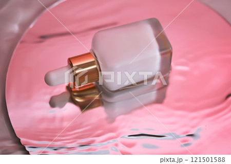 White serum with a pipette in water with a sunset atmosphere. 121501588