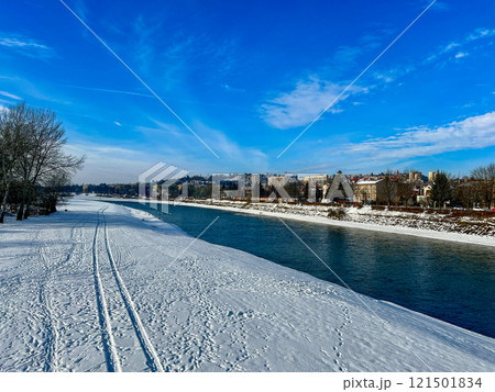 Panoramic winter landscape view with the blue sky on the banks of the San river at Przemysl, Poland  121501834