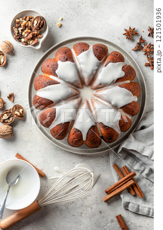 Christmas gingerbread cake glazed on white table with spices. Christmas festive dessert, homemade holiday baking recipe. Top view Christmas gingerbread cake glazed on white table with spices. Christmas festive dessert, homemade holiday baking recipe. Top view 121501936